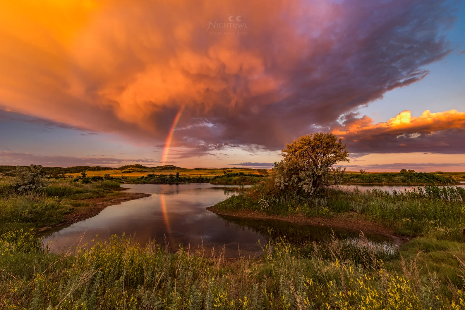A rainbow beneath an evening storm